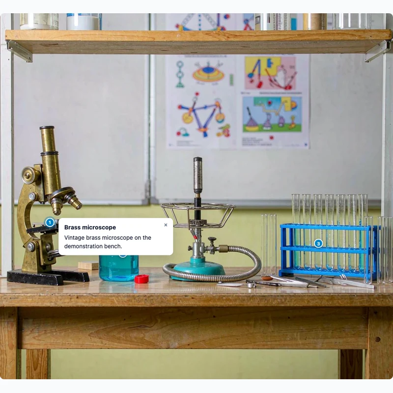 Science lab bench with hotspot notes on the microscope and beaker